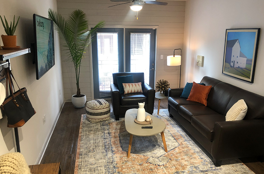 A furnished living room with a wall-mounted TV